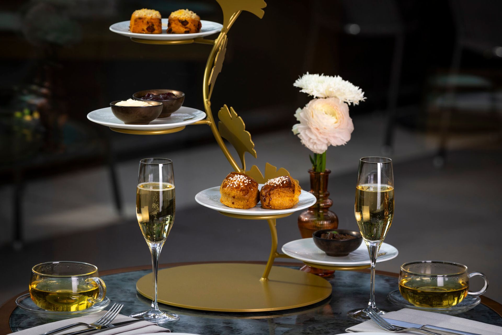 A table topped with plates of food and champagne glasses.