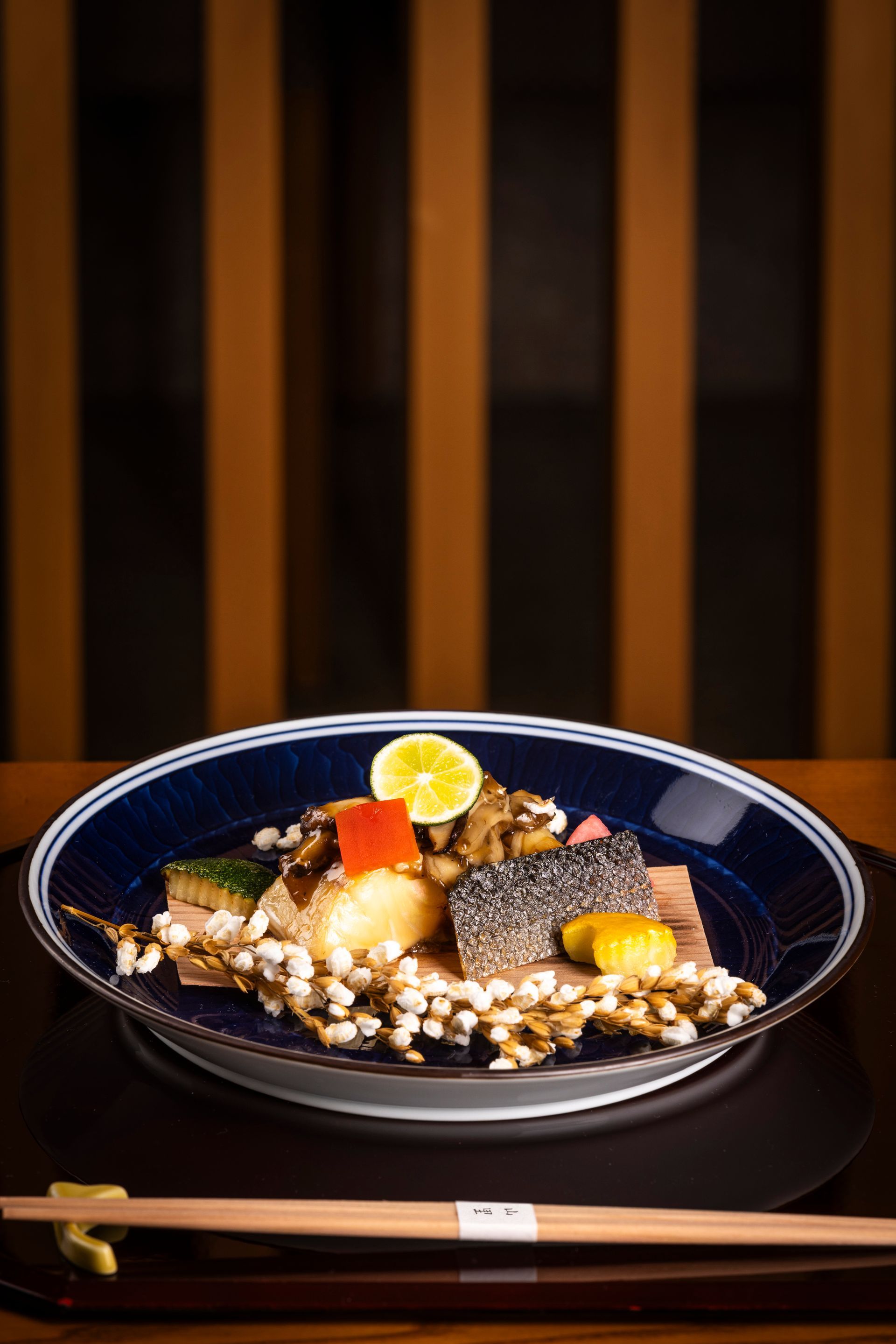 A plate of food with chopsticks on a table.