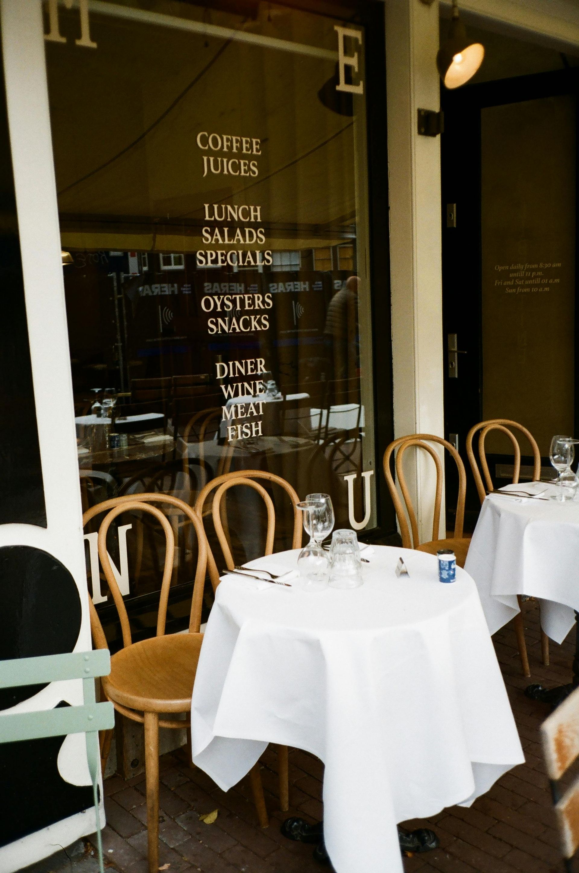 A restaurant with tables and chairs and a sign that says coffee kids