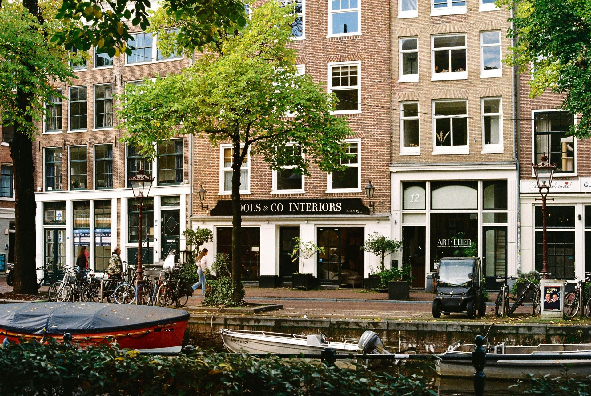 A row of buildings with one that says ' amsterdam ' on it