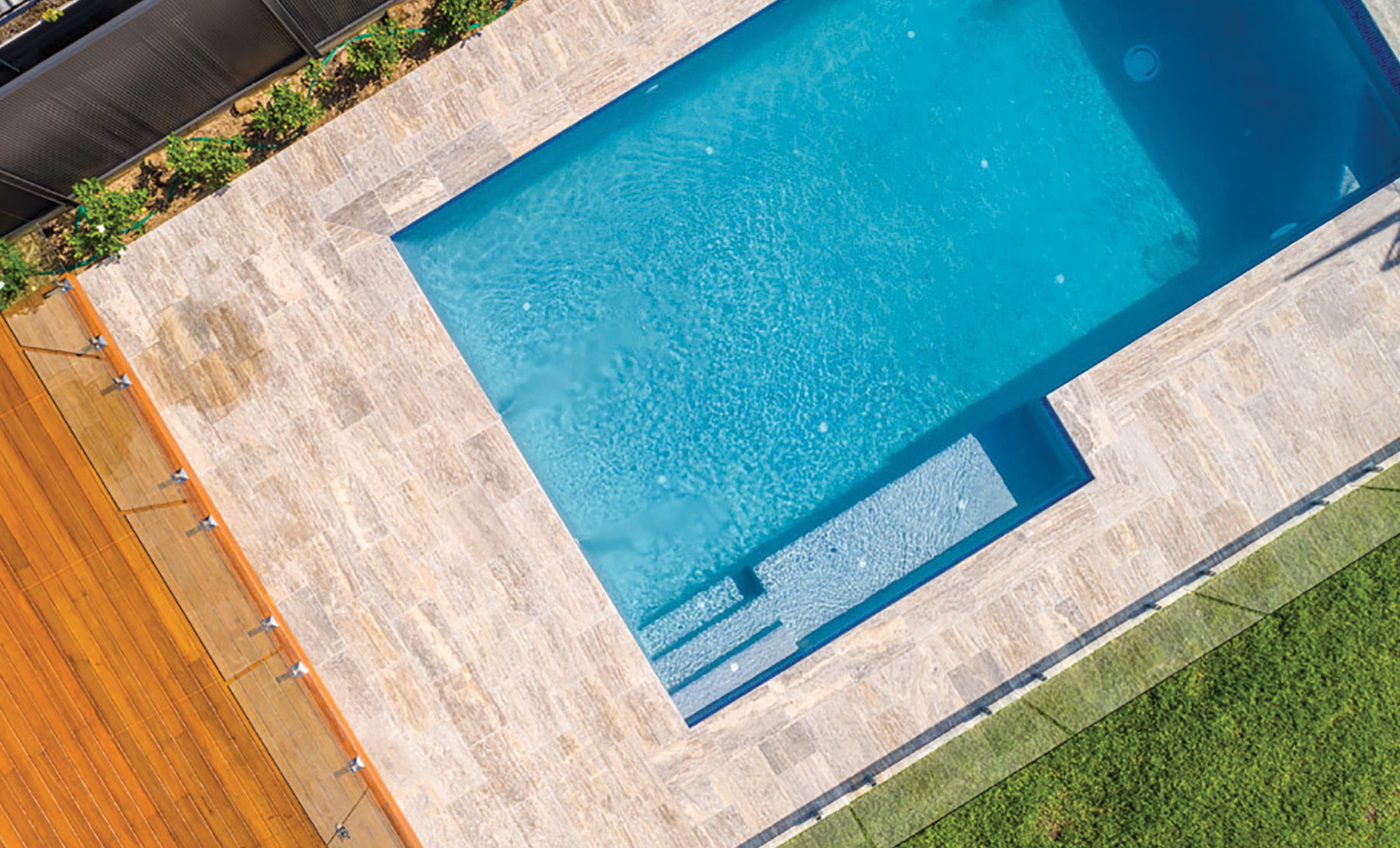 An aerial view of a large swimming pool in a backyard.