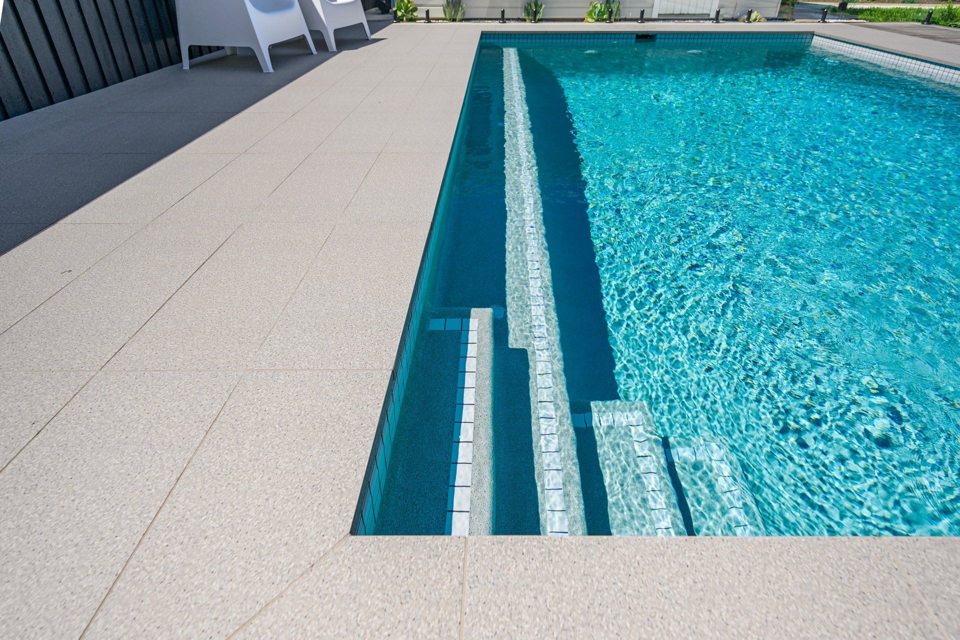 A large swimming pool with stairs leading to it