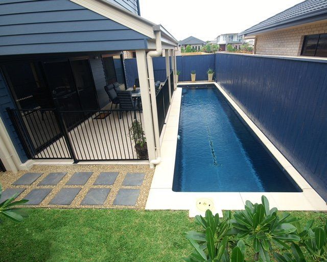 A swimming pool with a blue fence surrounding it