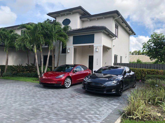 Modern House With Two Cars Parking Outside — Miami, FL — Solar Tint, Inc.