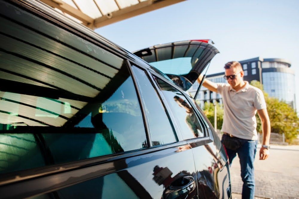 A close-up of a side of a car with ceramic-tinted windows - one of the best ways to keep your car cool in summer​