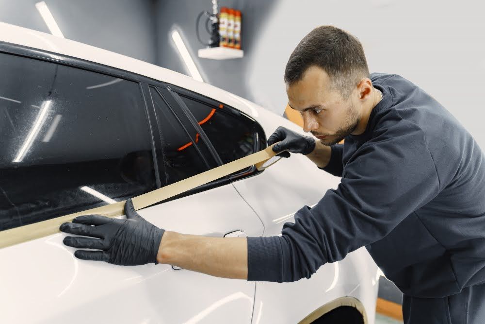 A skilled technician applying the best window tint for Florida weather & climate conditions.