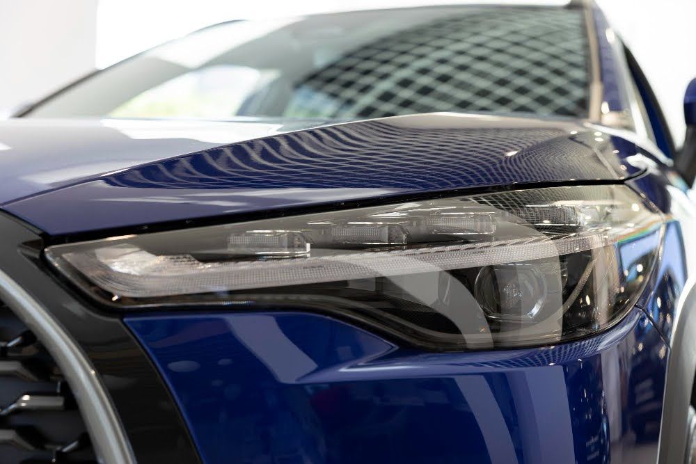 Close-up shot of freshly installed paint protection film on a car.