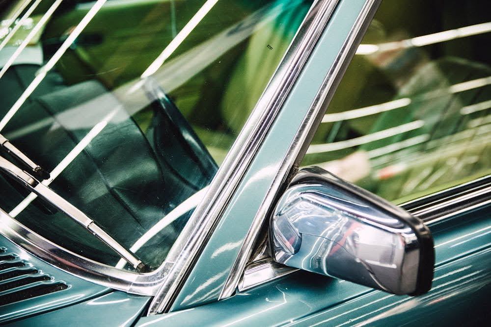 A close-up of a car with a well-maintained windshield and side windows.