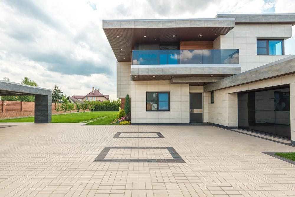 An exterior of a modern home with decorative window film applied to the windows.