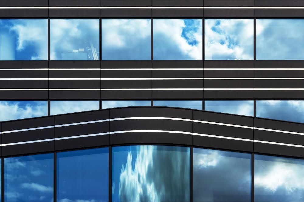 A modern building glass facade with tinted windows.
