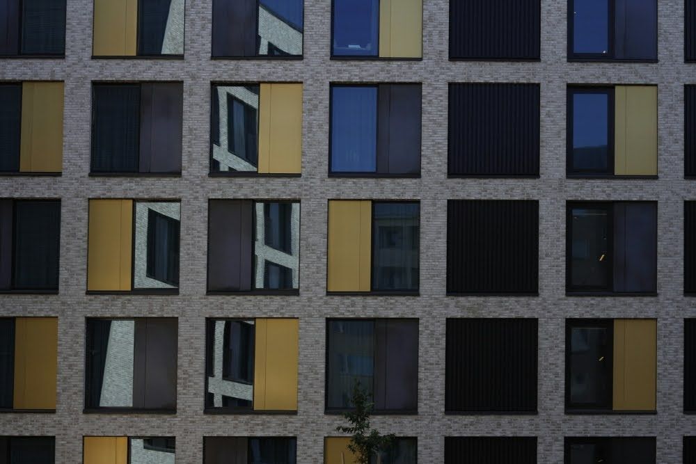 Sunlight reflecting off building windows, demonstrating the benefits of commercial window tinting.