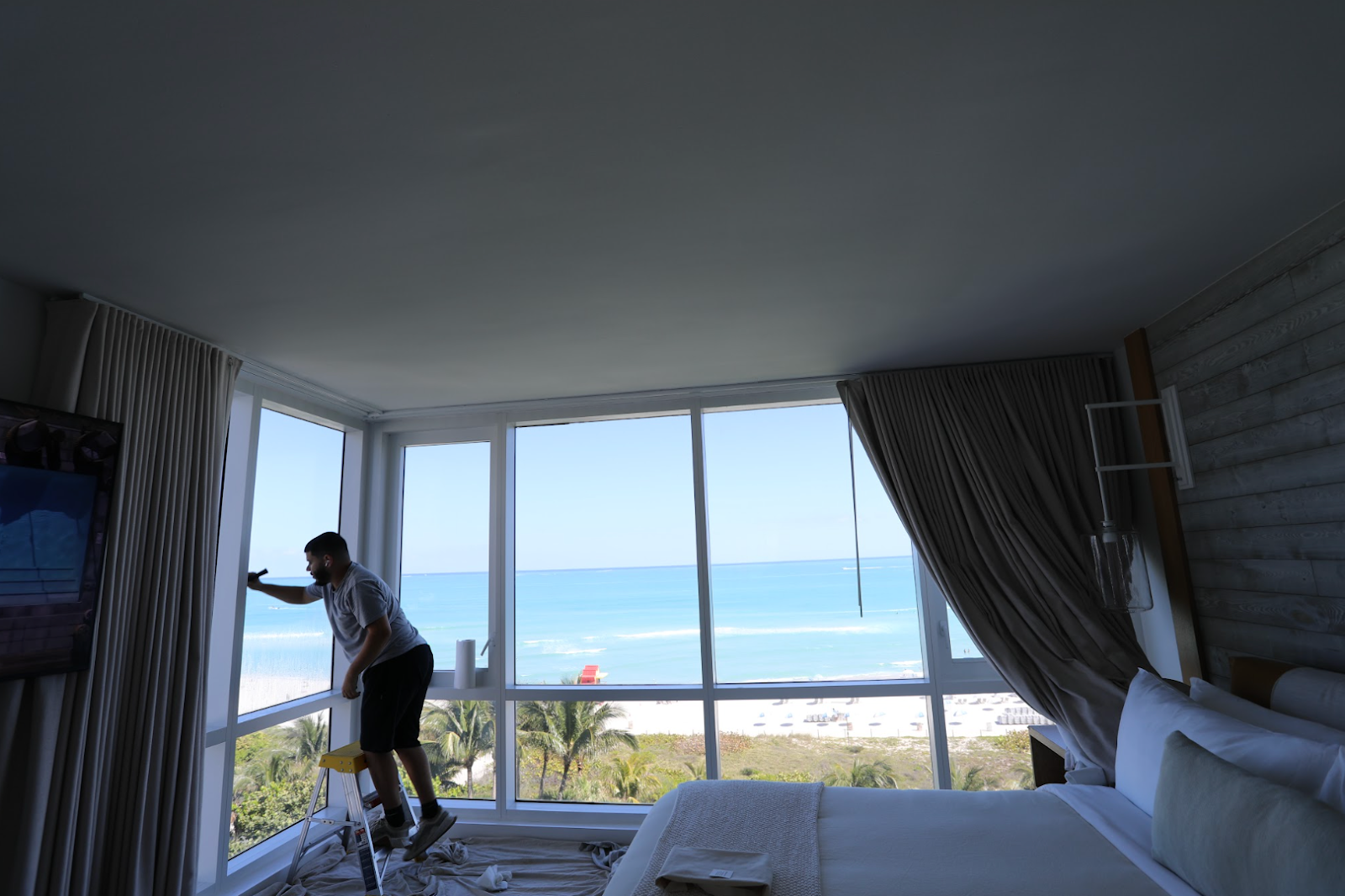 Installer applying the best window film for hotels with an ocean view.