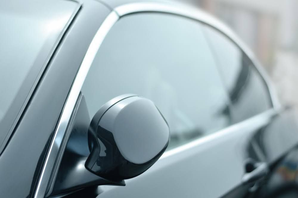 Close-up of professionally installed ceramic tint on a car window.