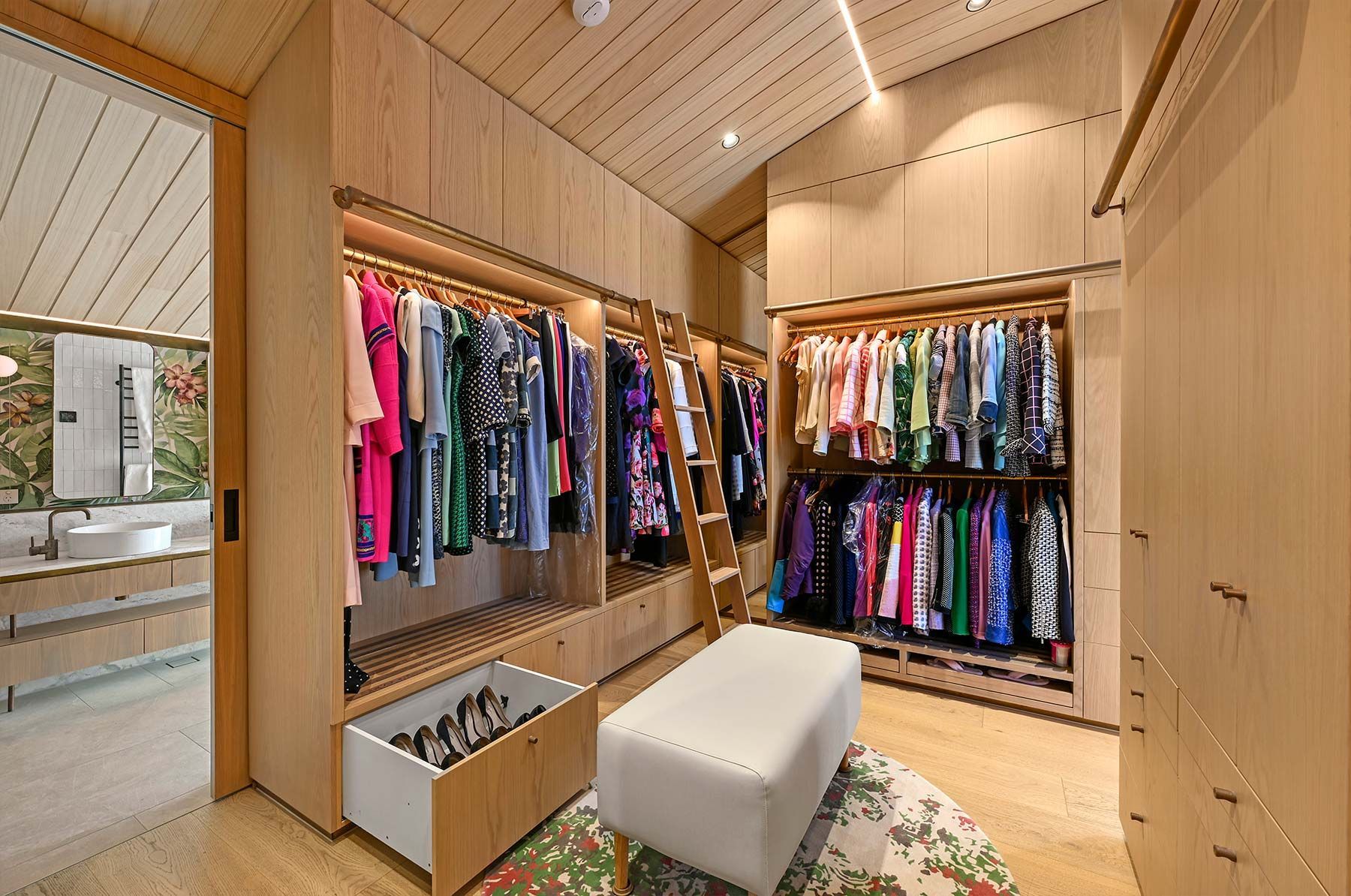 Spacious Walk-in Closet With Light Wood Cabinets — PK Kitchen Design in West Ipswich, QLD