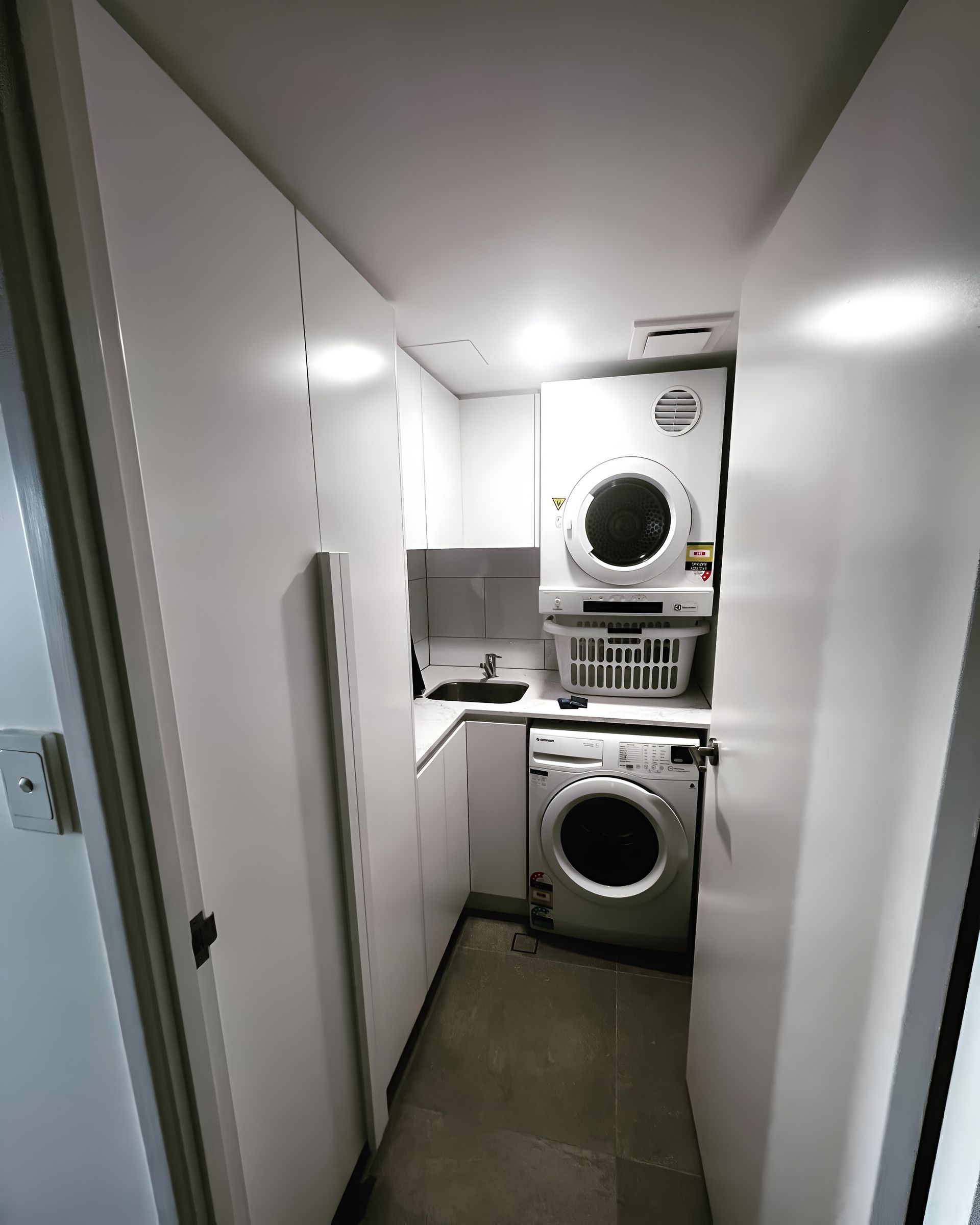 Laundry Room With Stacked Washer and Dryer — PK Kitchen Design in West Ipswich, QLD
