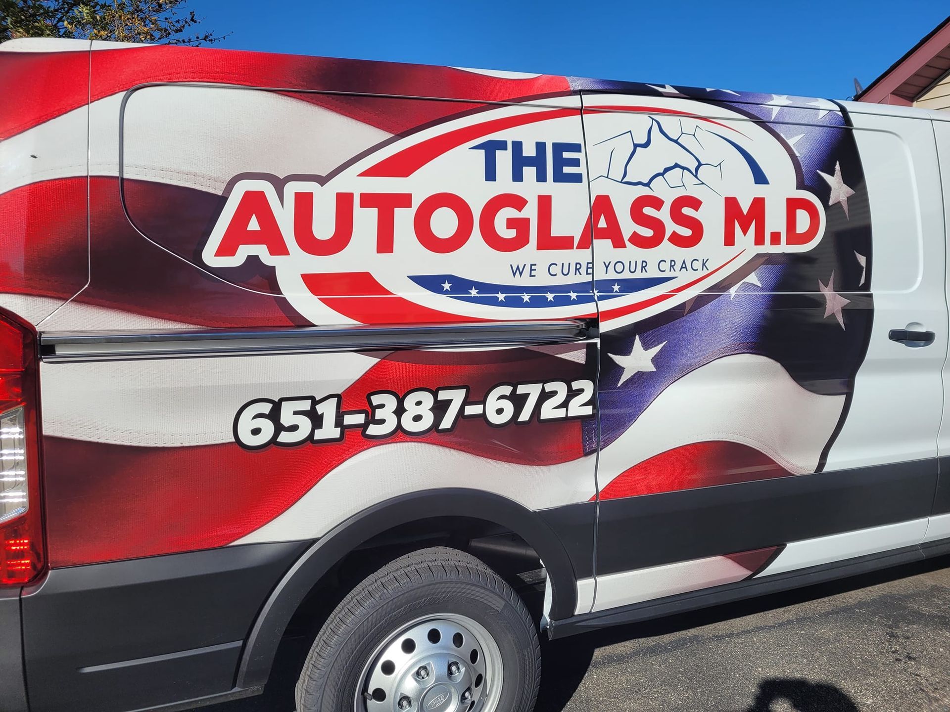 A white van with the autoglass m.d. logo on it