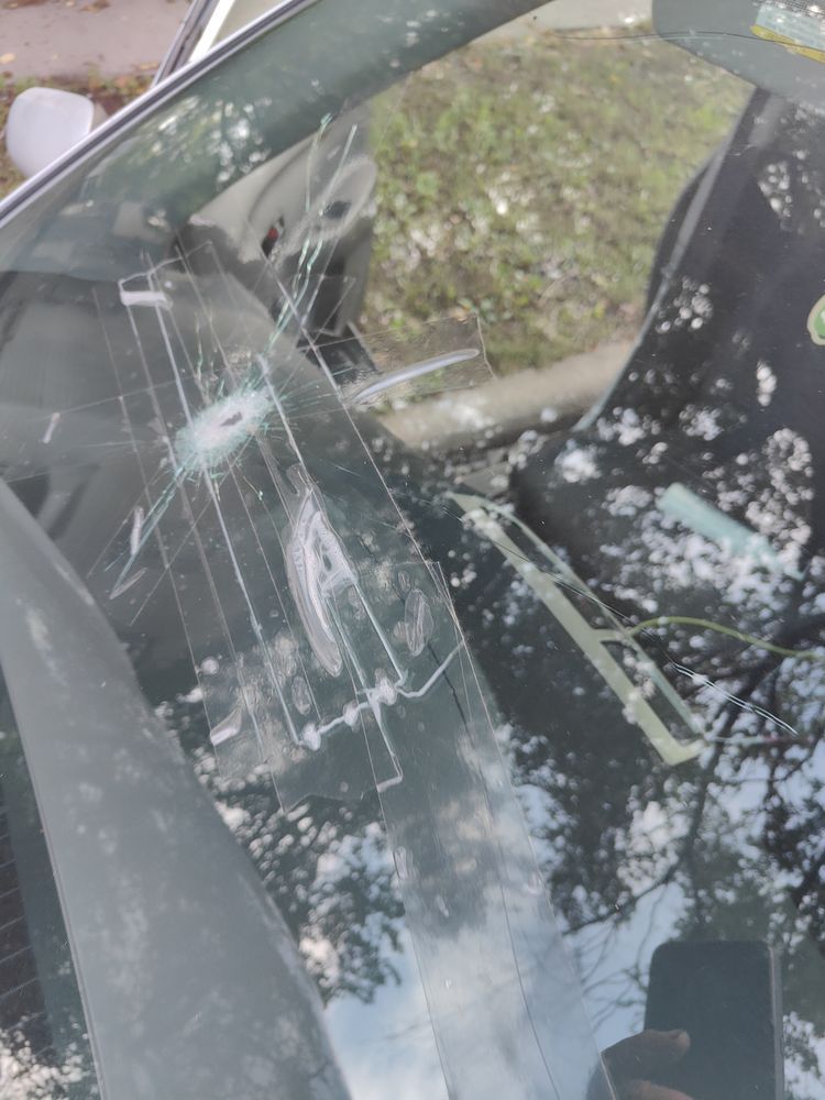 A close up of a broken windshield of a car