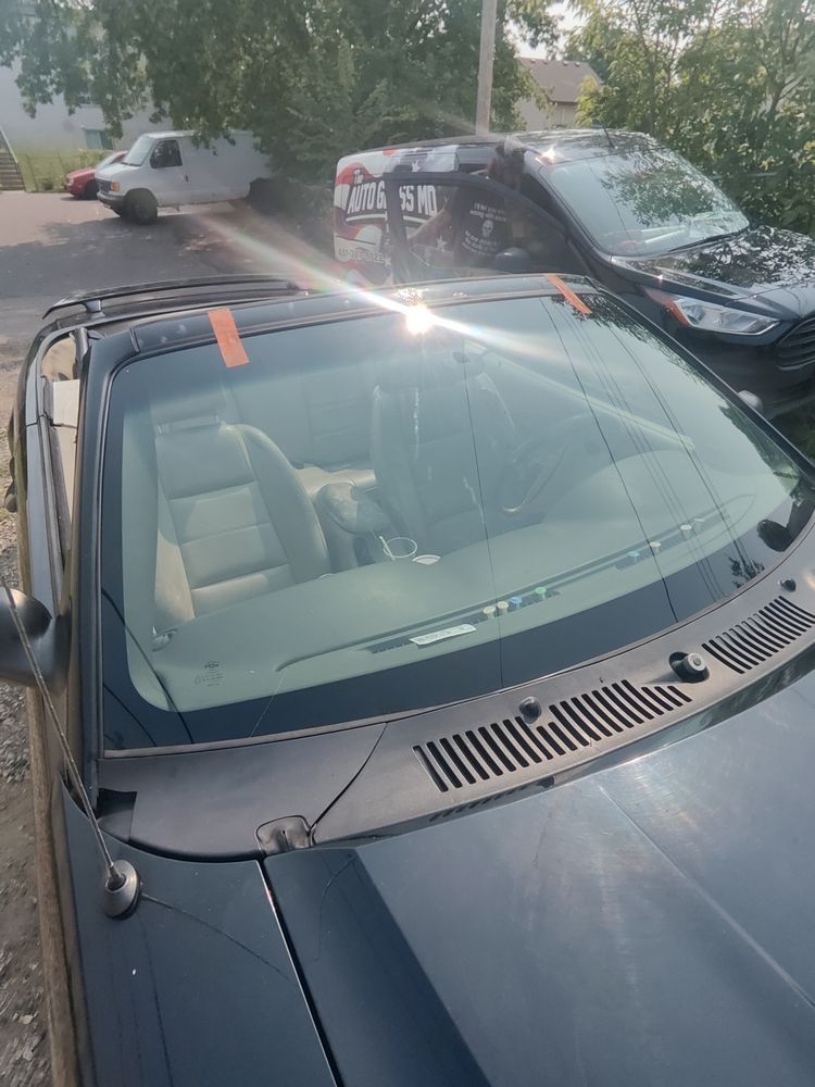 Two cars are parked next to each other on the side of the road.