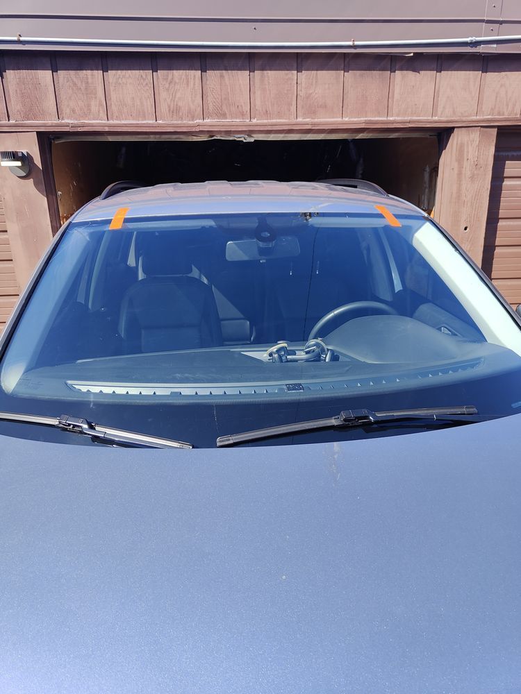 A car is parked in front of a garage door
