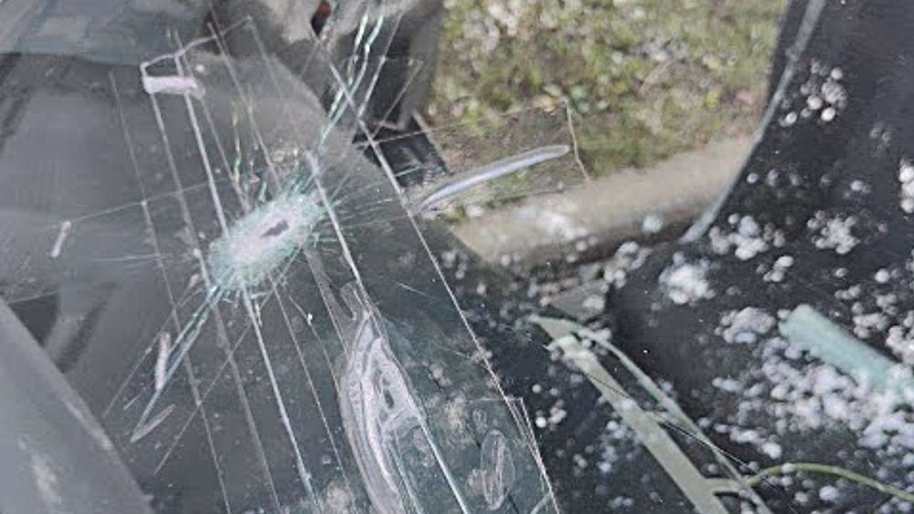 A close up of a broken windshield of a car.