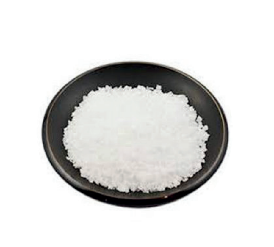 Uma tigela preta cheia de pó branco sobre um fundo branco.