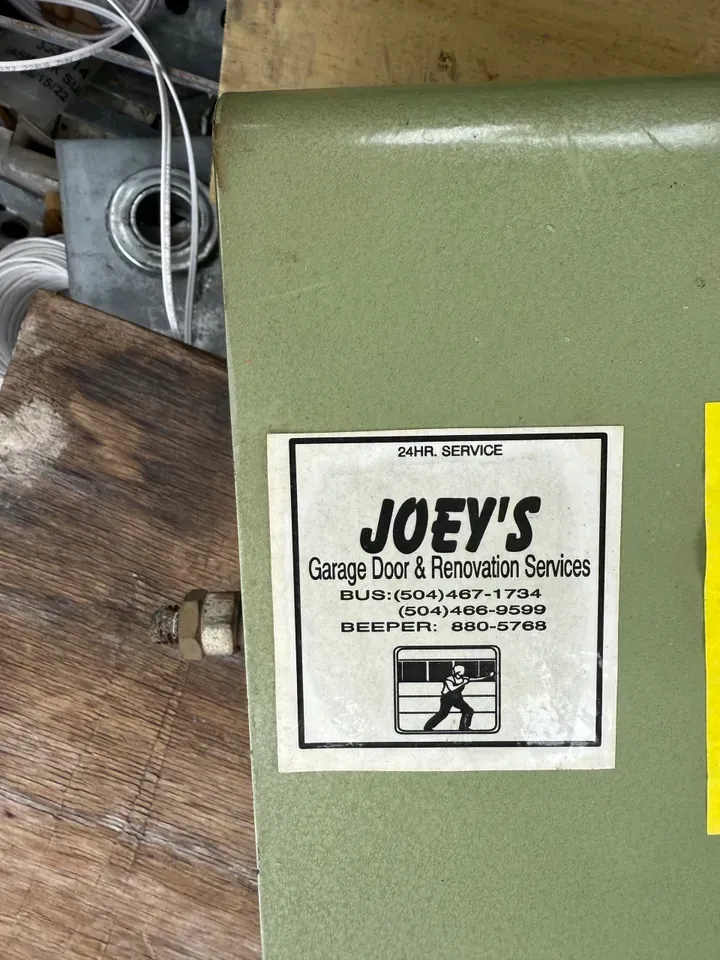 A green metal box with a business sticker for 