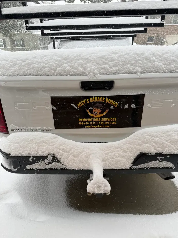 Snow-covered white truck with a 