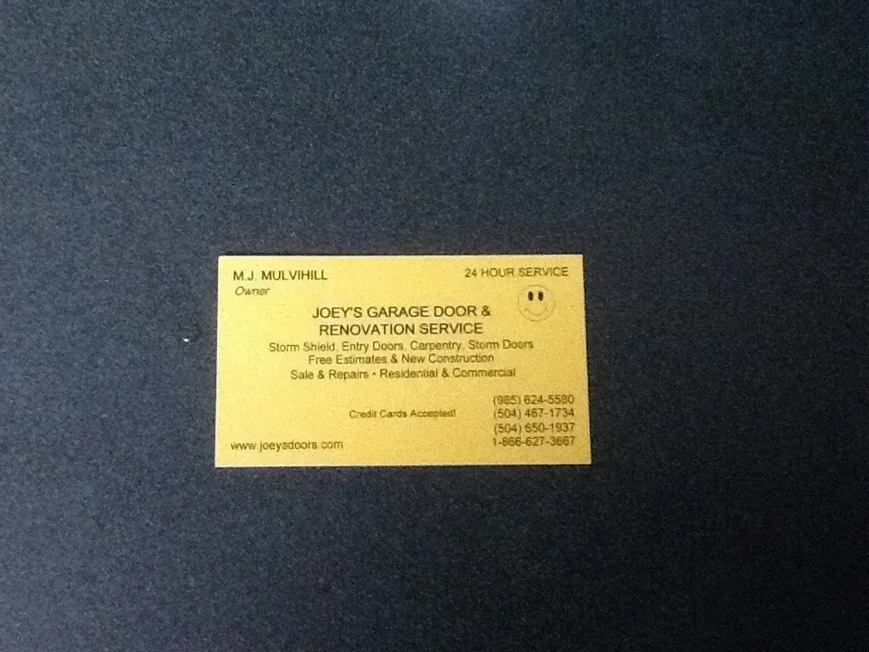 Yellow business card on blue background: Joey's Garage Door & Renovation Service. 
