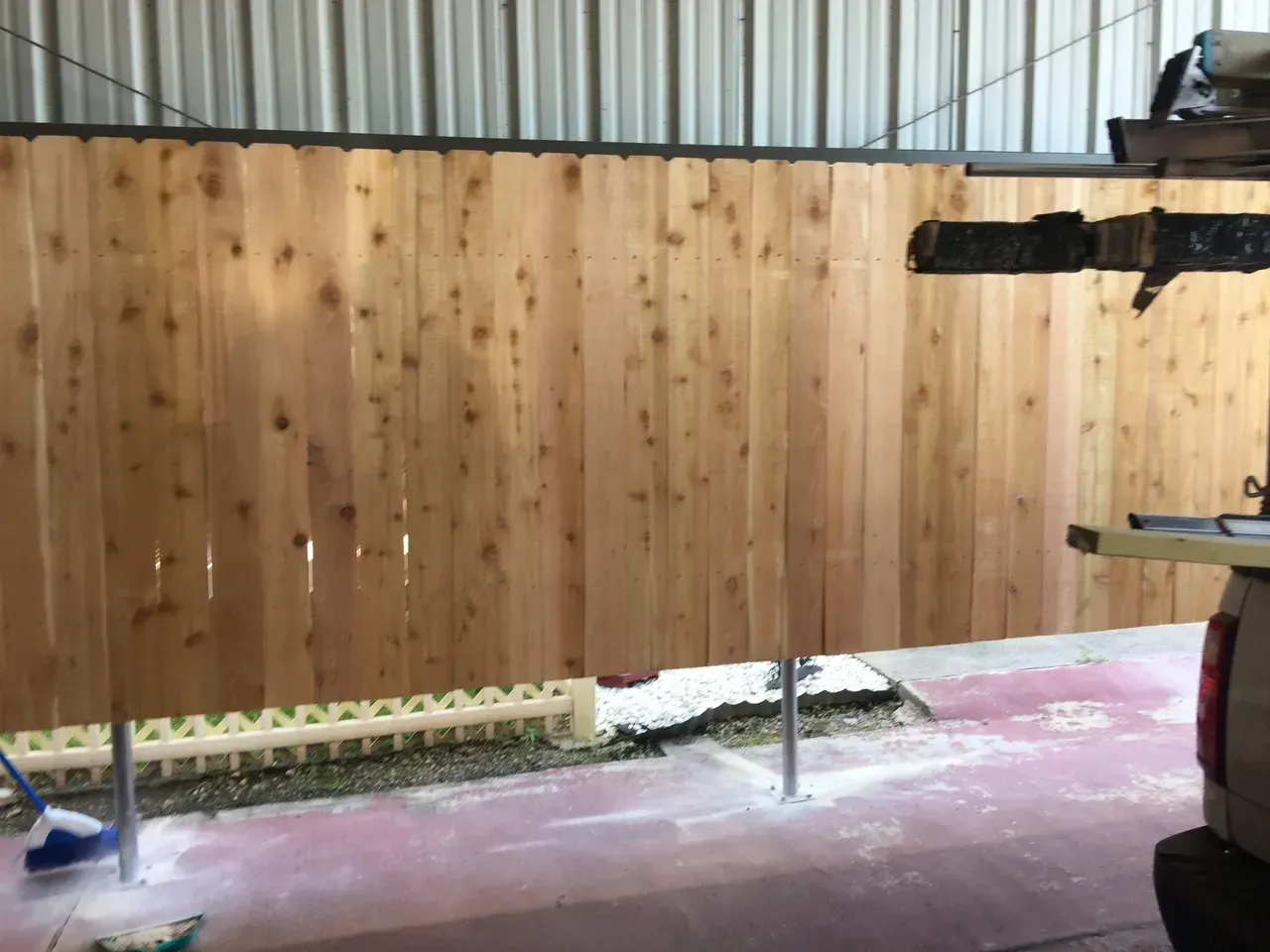 Wooden fence inside a building, possibly under construction.