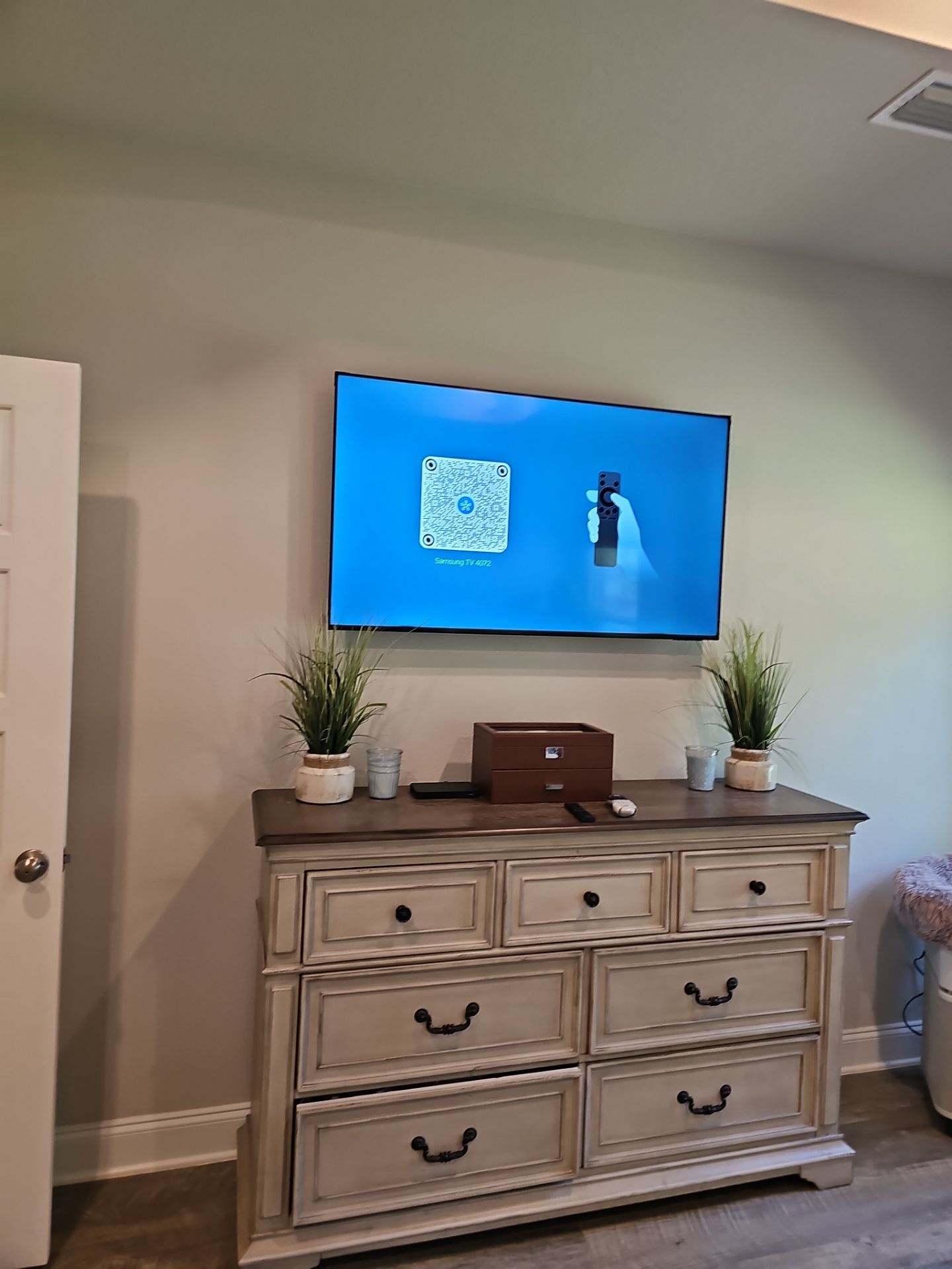 Flat screen TV wall-mounted in [room type] in [city, state]