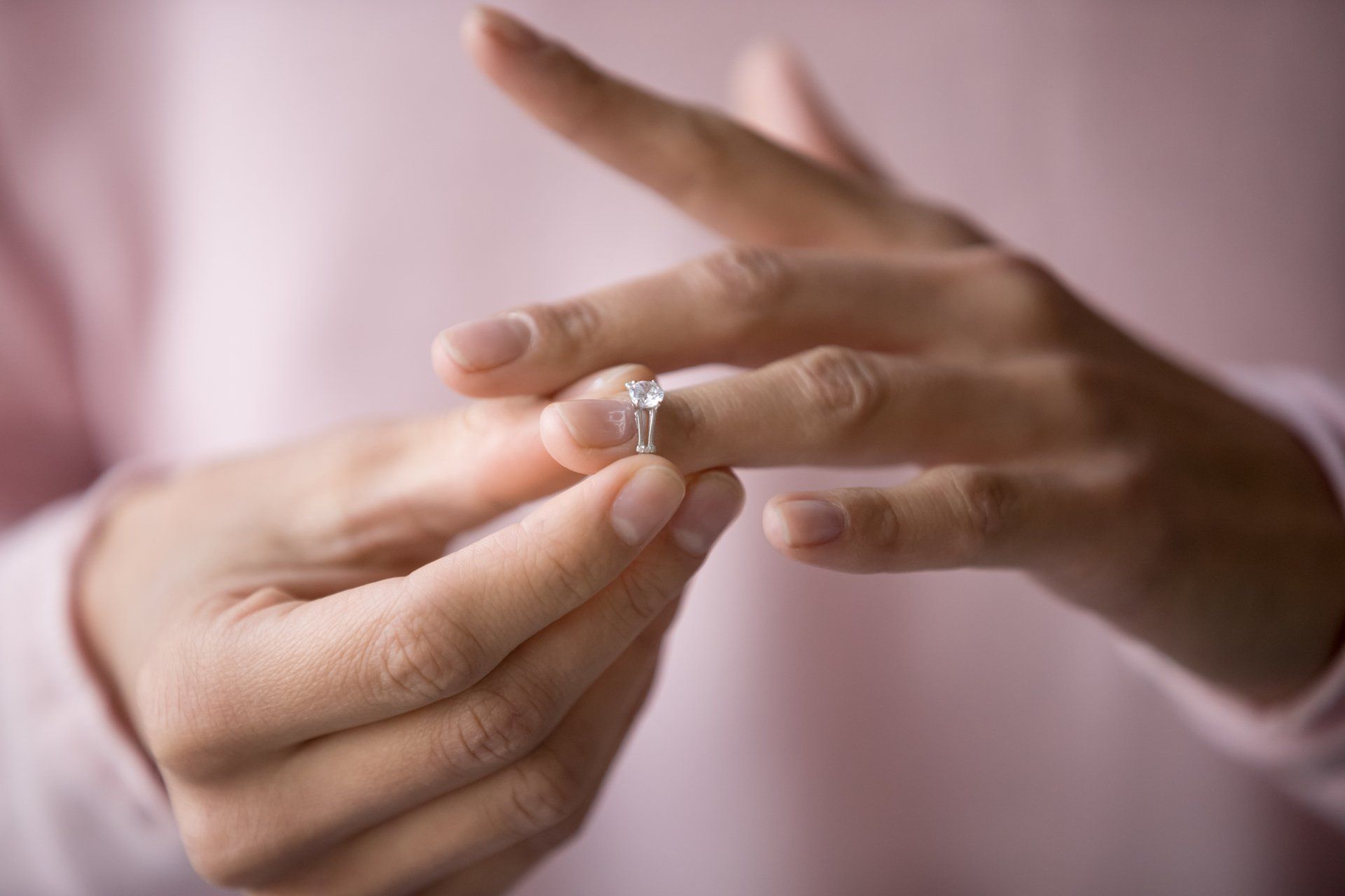 Close up of decisive woman take off wedding ring make decision breaking up with husband, young female remove engagement jewelry having relationships problems filing for divorce or annulment  F