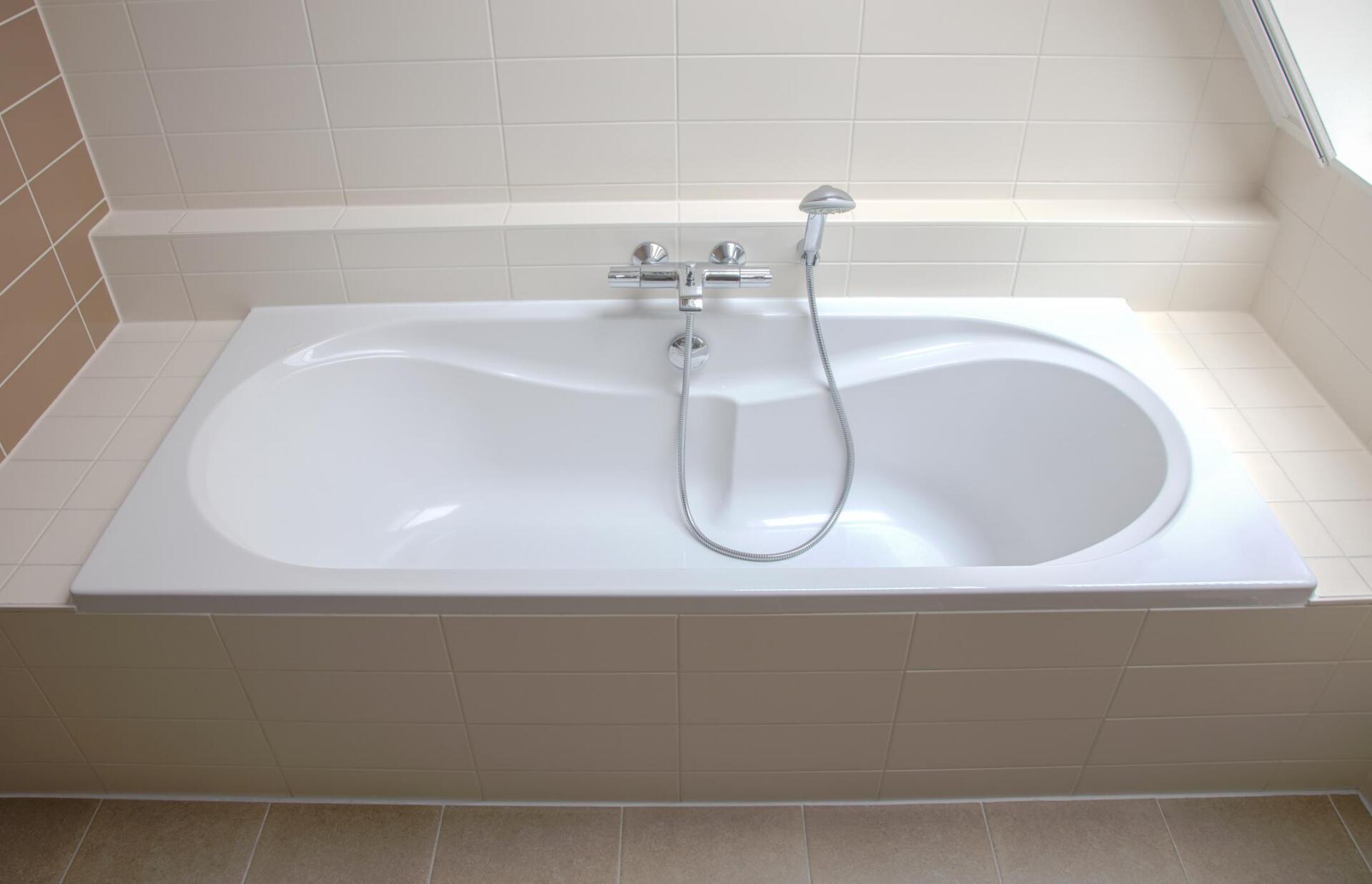 white bathtub with faucet