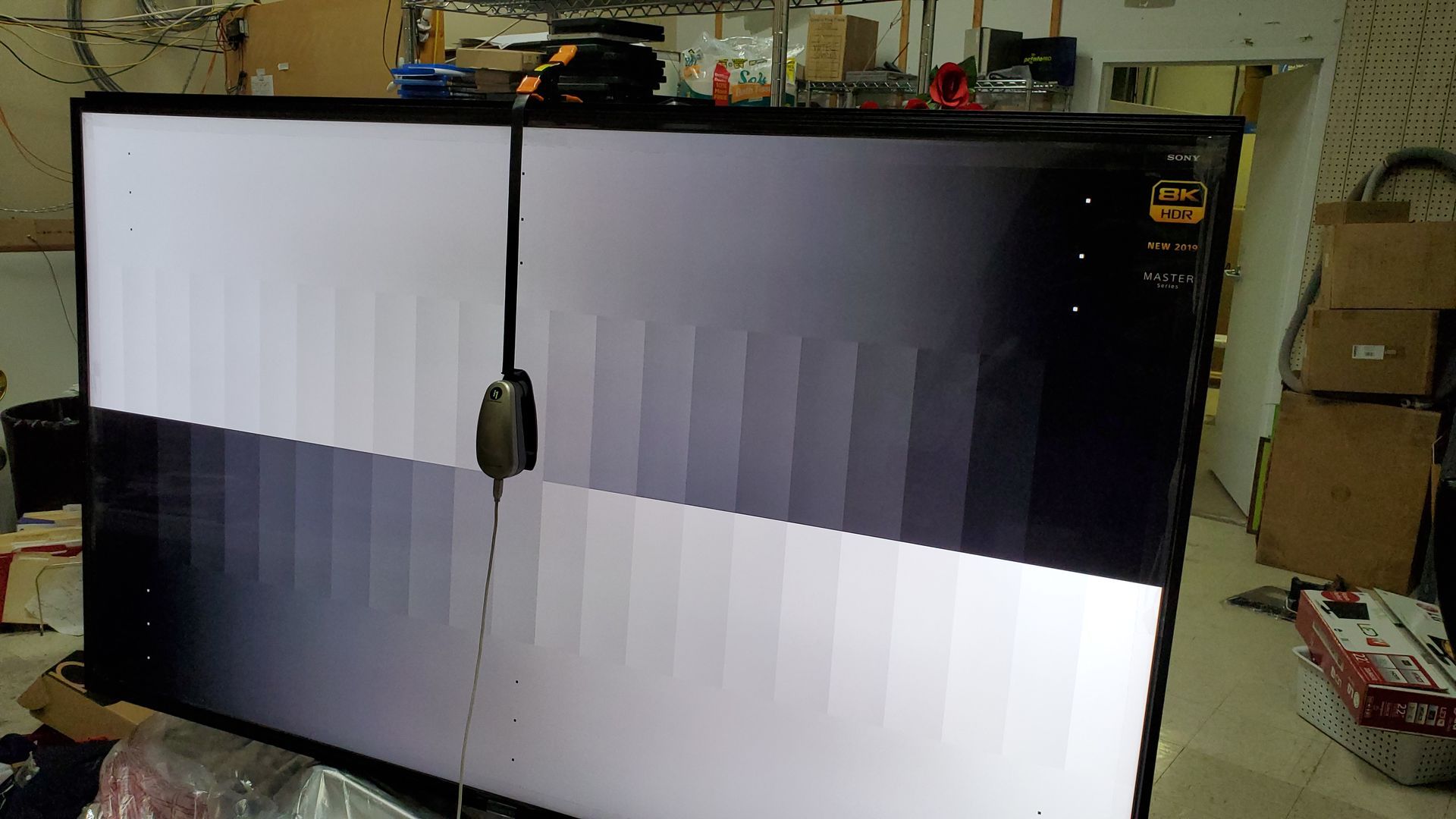 A large flat screen tv is sitting on a table in a room.