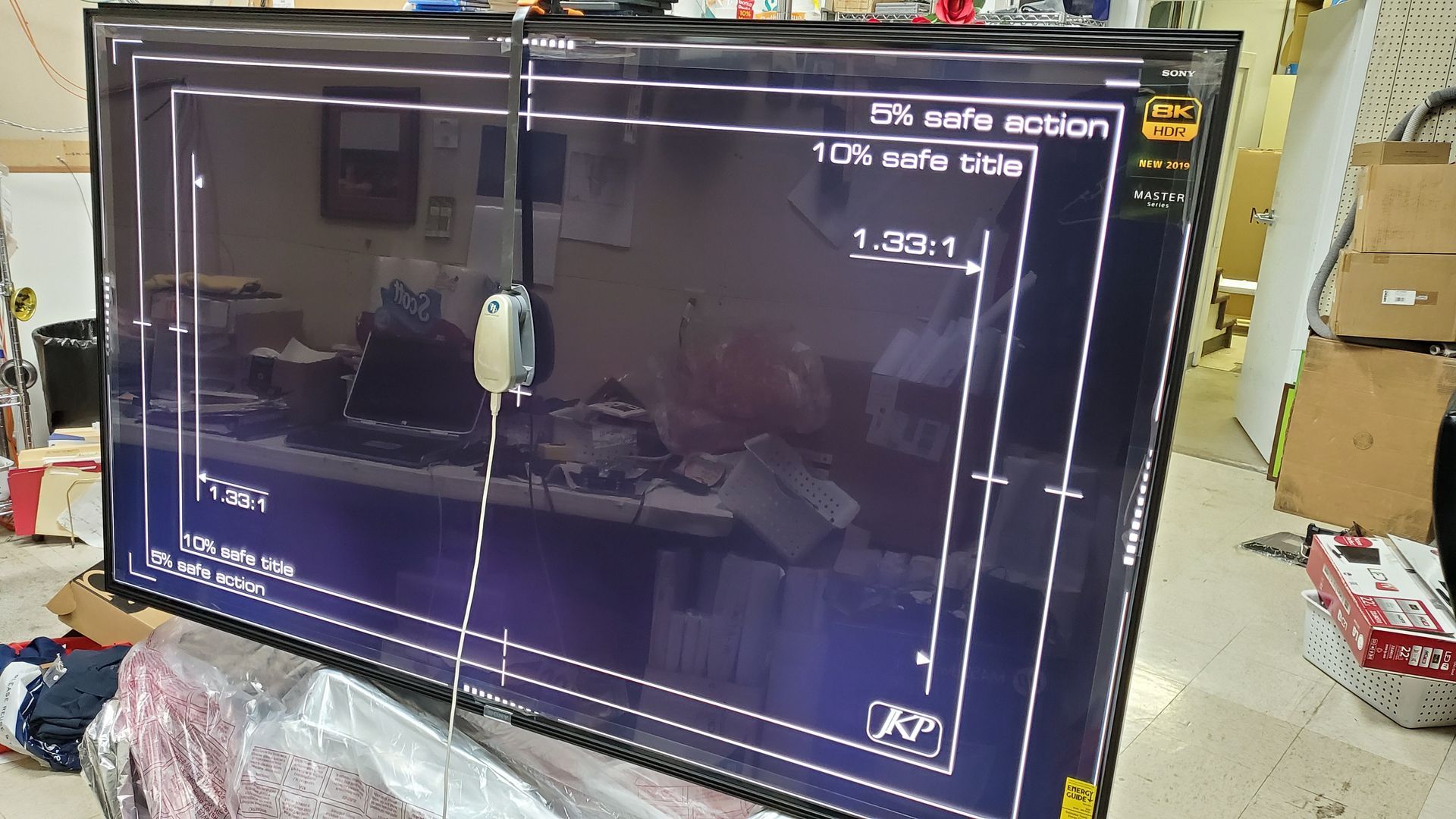 A large flat screen tv is sitting on top of a table.