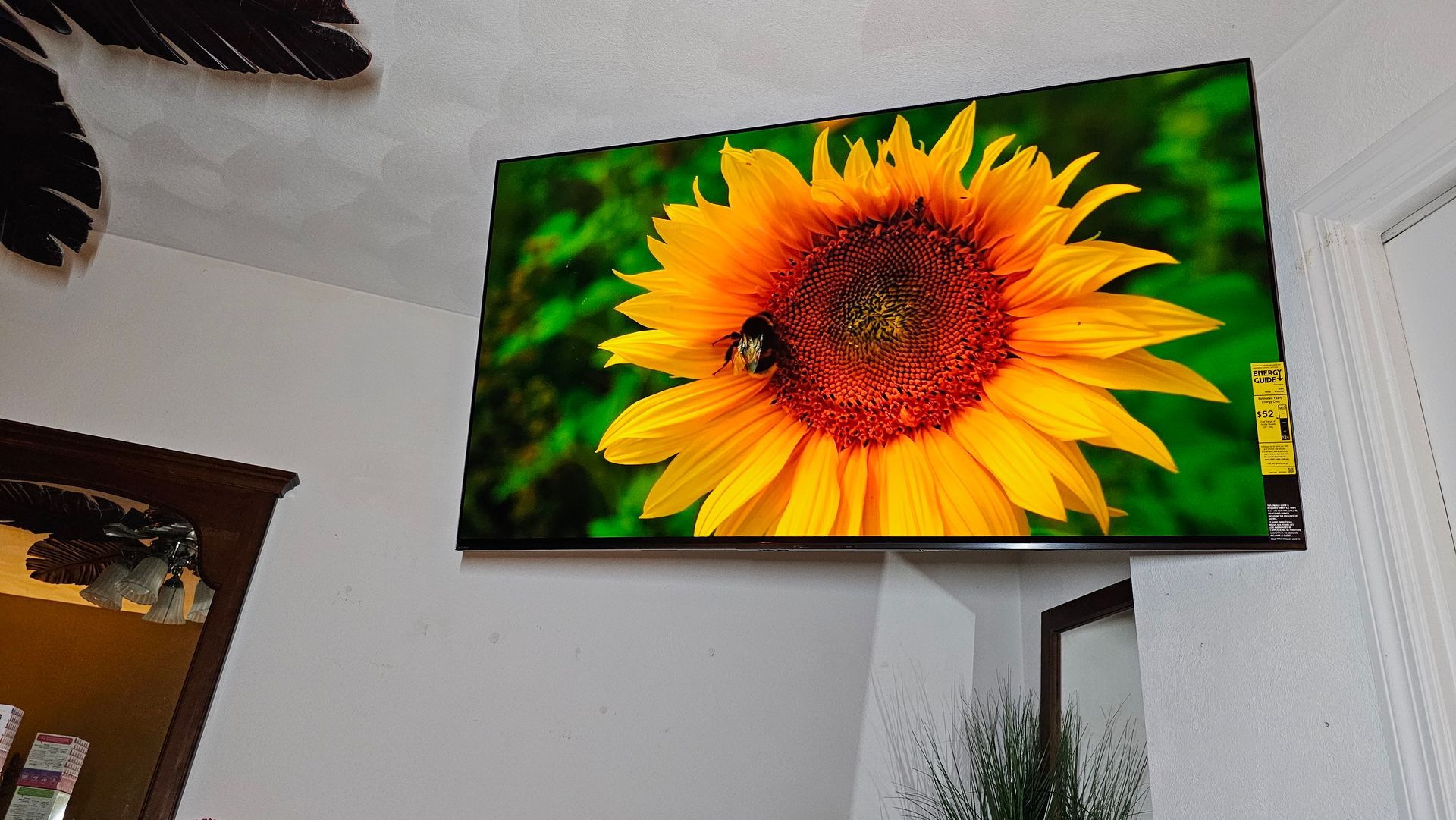 A picture of a sunflower is hanging on a wall