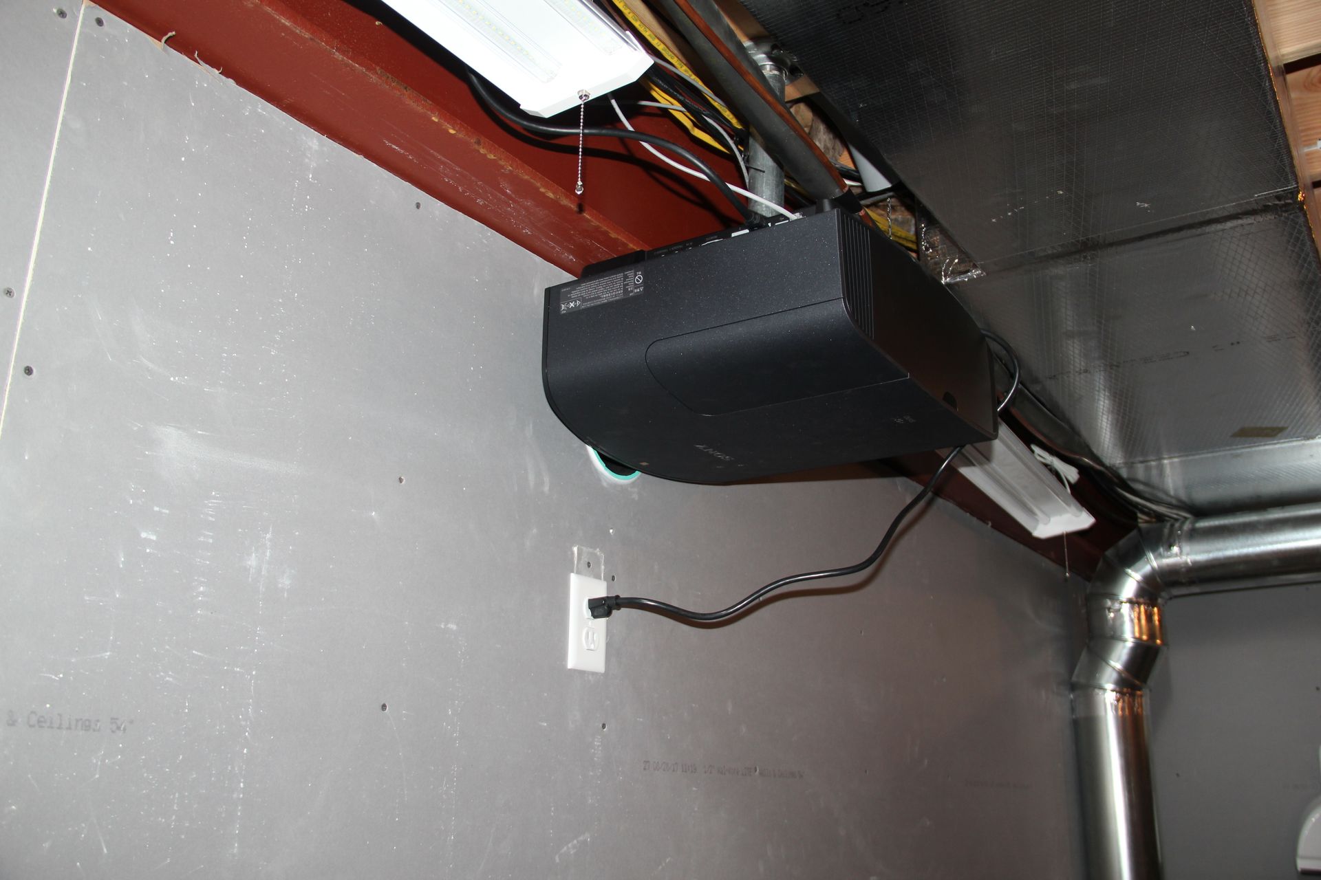 A black box is hanging from the ceiling of a room