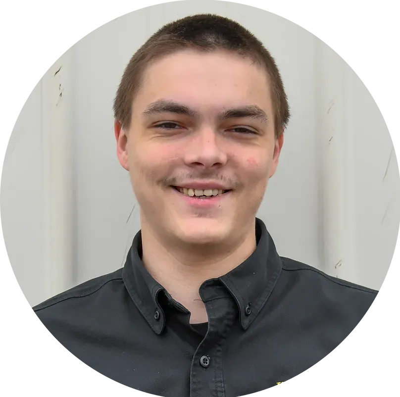 A young man in a black shirt is smiling in a circle