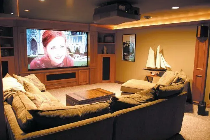 A home theater with a large screen and a couch