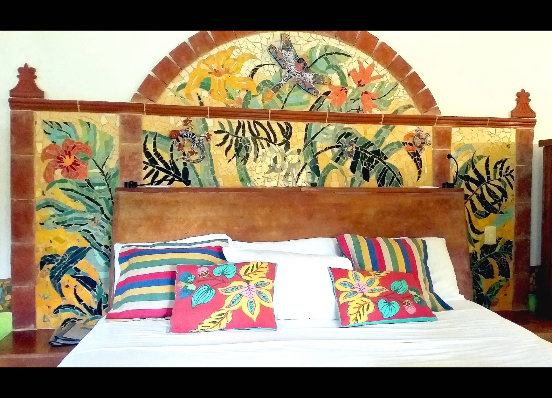 Mosaic headboard on elevated bed
