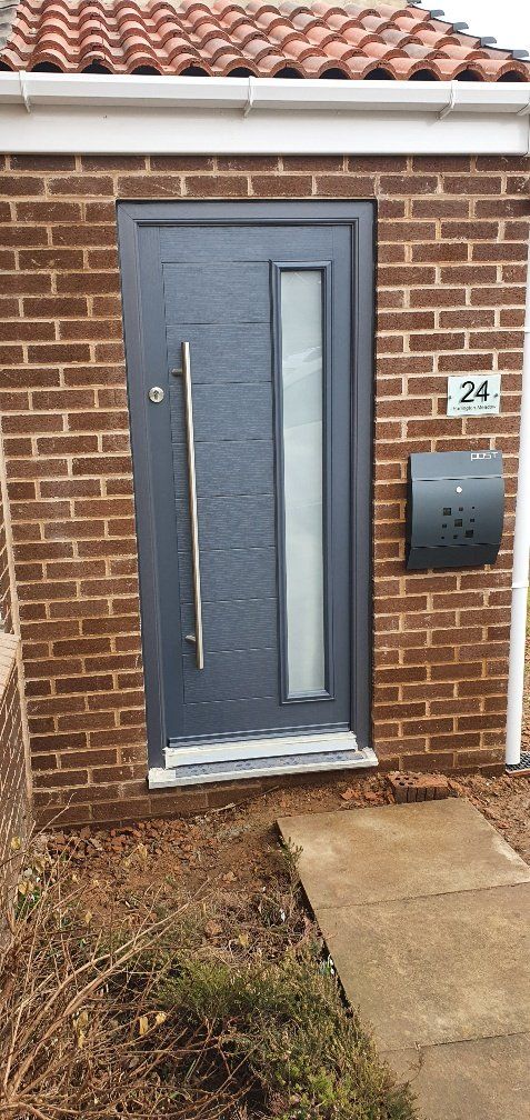 modern grey composite doorset with long bar handle