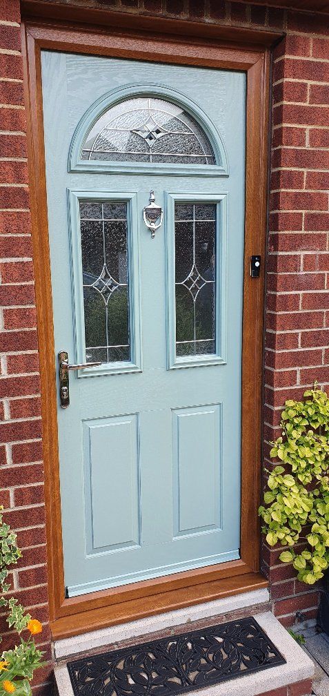 A light blue front door with a wooden frame