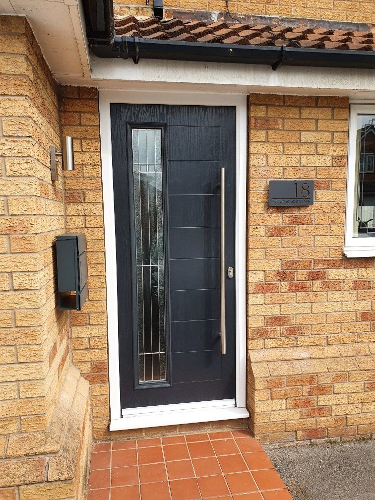 A black front door with a stainless steel handle