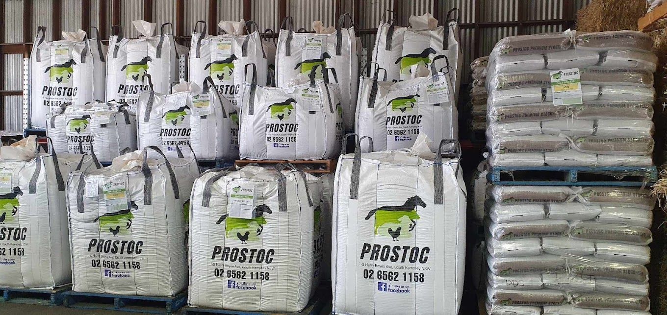 A Bunch Of Bags Of Hay Are Stacked On Top Of Each Other In A Warehouse — Prostoc In Bellbrook, NSW