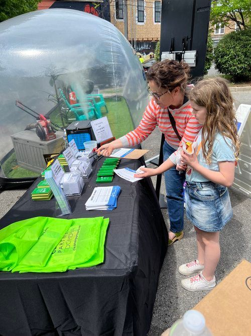 A woman and a little girl are standing at a table