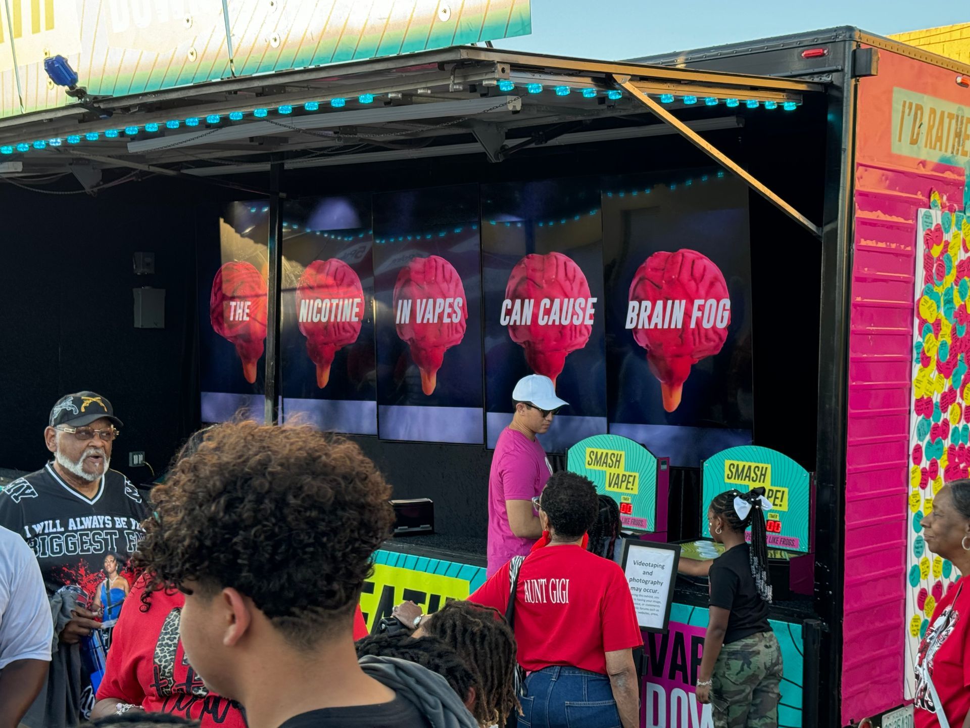 A group of people standing in front of a booth that says brain fog
