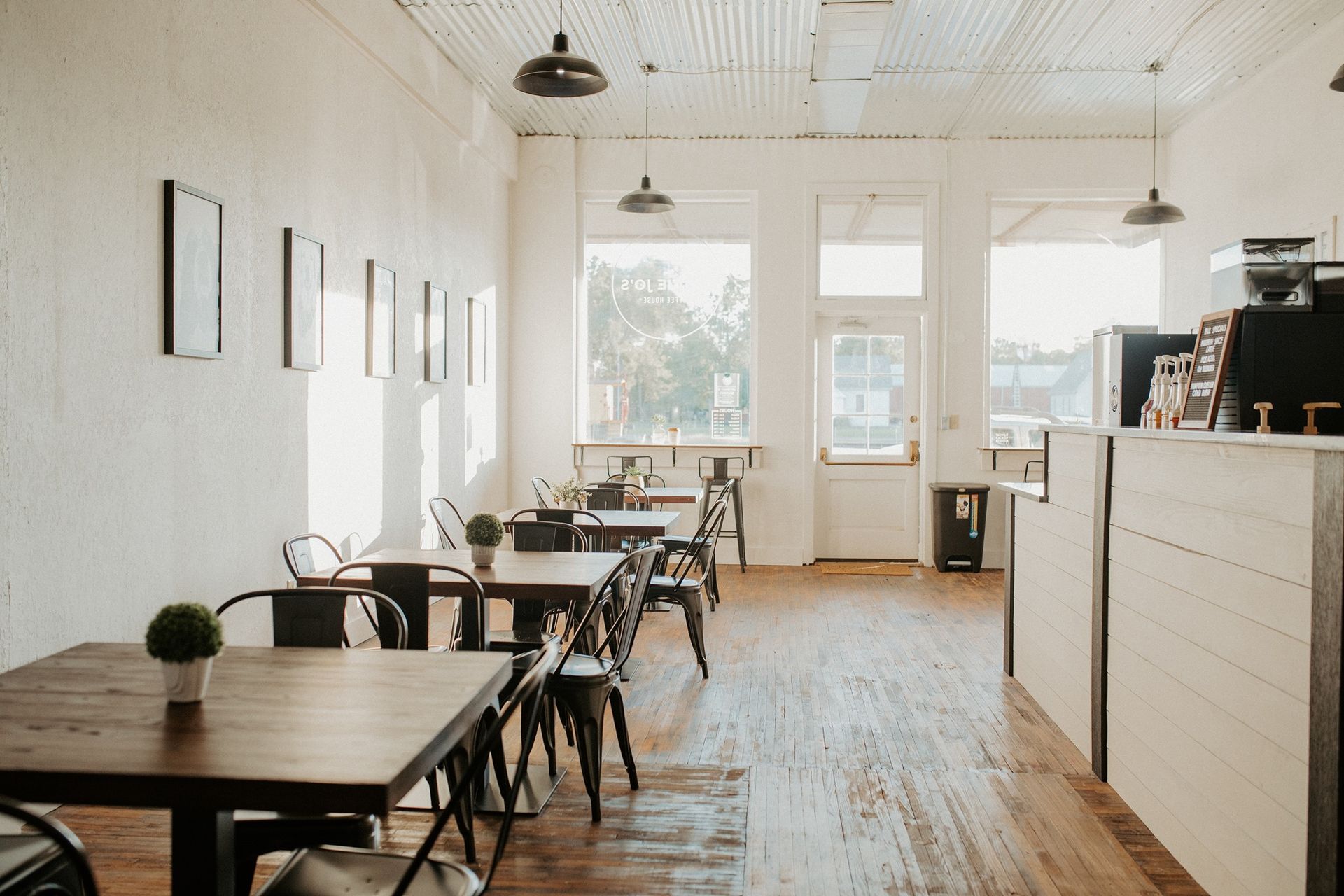 A restaurant with tables and chairs and a counter.
