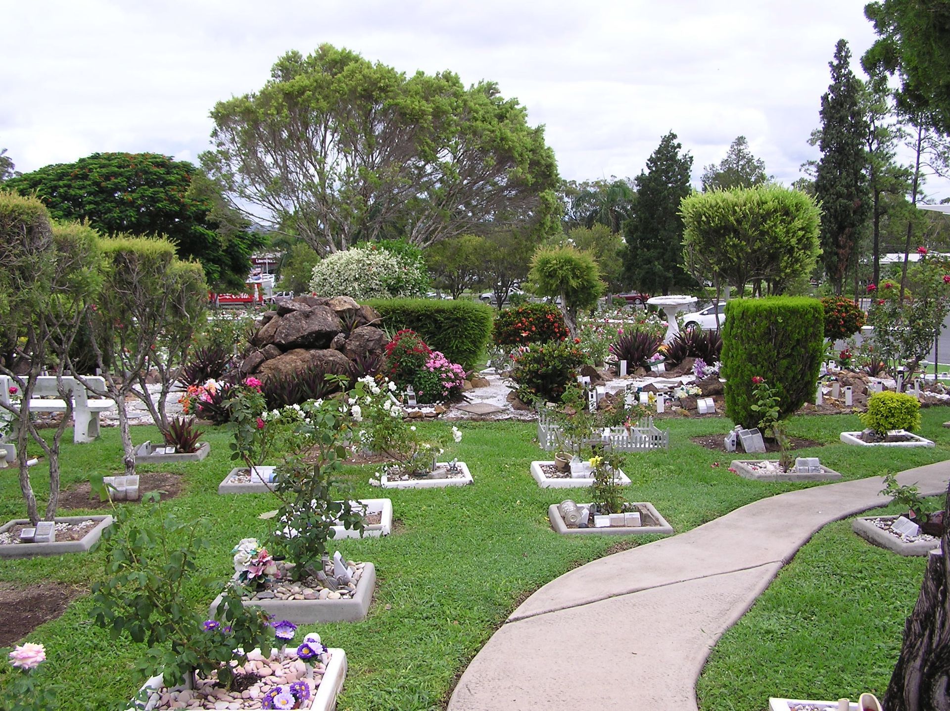 a garden with flowers and stones — Rockhampton Crematorium in Norman Gardens, QLD