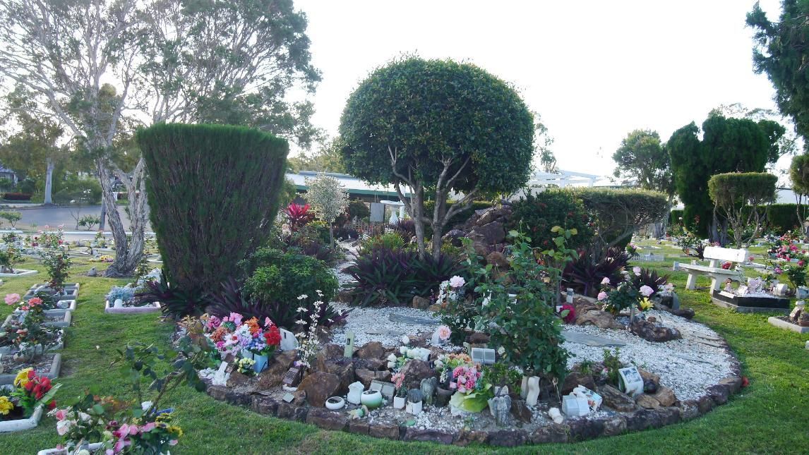 A Well-Maintained, Colorful Gravesite in A Cemetery, Surrounded by Greenery and Trees — Rockhampton Crematorium in Norman Gardens, QLD