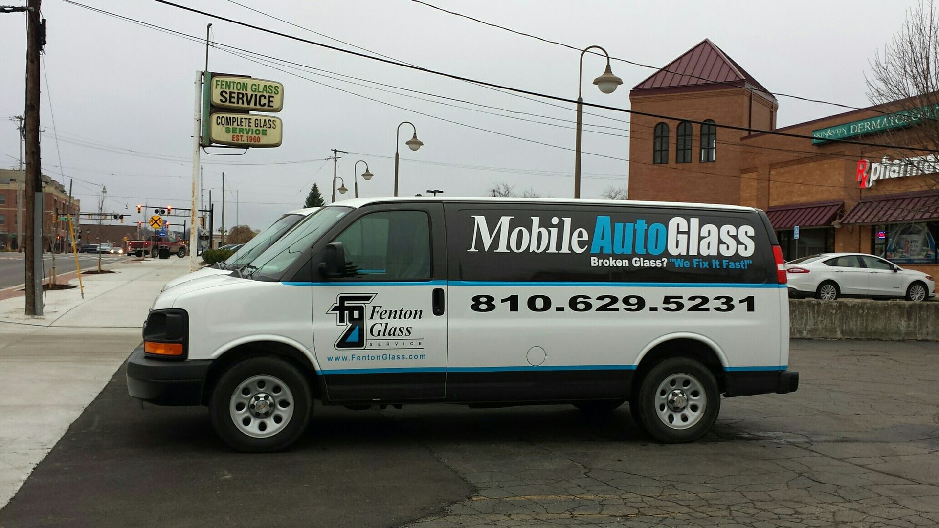 A white van with mobile auto glass written on it