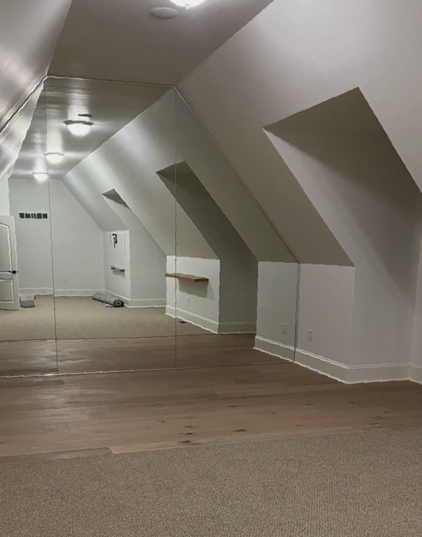 There is a large mirrored wall in the middle of the room.